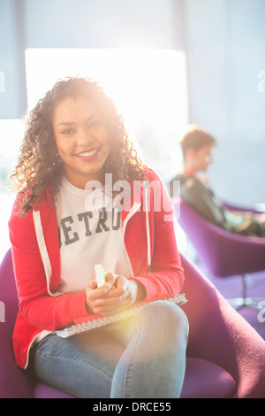 University Student smiling in lounge Banque D'Images