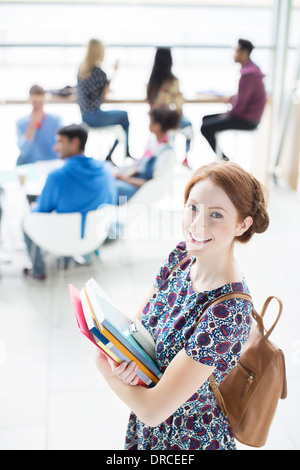 University Student smiling in lounge Banque D'Images