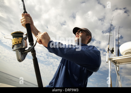 USA l'homme sur le bateau holding canne à pêche Banque D'Images