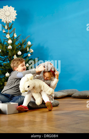 Enfants jouant avec des ours en peluche le soir de Noël, Munich, Bavière, Allemagne Banque D'Images