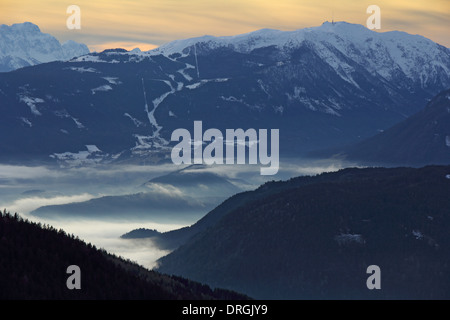 Coucher du soleil dans les montagnes bleues, dans la vallée au-dessous de l'épais brouillard Banque D'Images