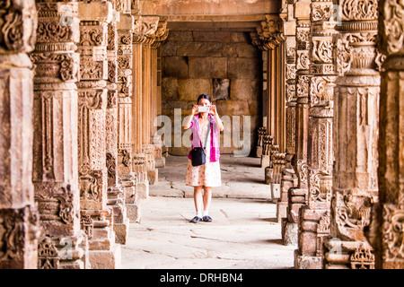 Touriste Américain asiatique prend une photo au complexe de Qutb Minar, Delhi, Inde Banque D'Images