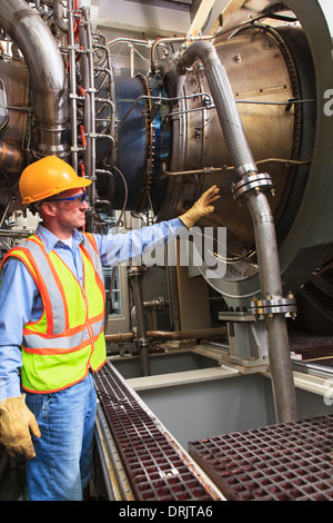 Ingénieur au stade de l'allumage du carburant qui entraîne la turbine à gaz Générateurs dans power plant alors qu'éolienne est mis hors tension Banque D'Images