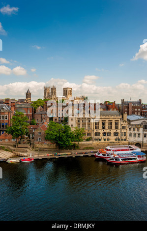 Vue en hauteur des bateaux de touristes amarrés sur la rivière Ouse Avec le Guildhall et York Minster au loin Banque D'Images