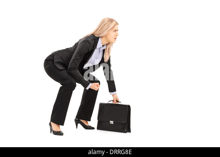 Young businesswoman in position sumo holding suitcase Banque D'Images