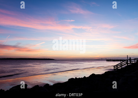 De soleil colorés reflétée sur Saint Simons Island Beach en Géorgie. Le Sydney Lanier Bridge peut être vu dans la distance. Banque D'Images