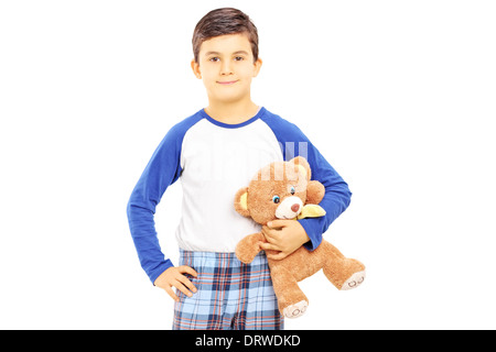 Boy in pajamas holding teddy bear Banque D'Images