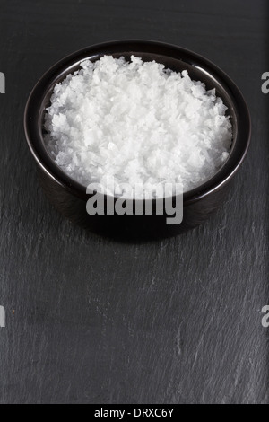 Flocons de sel de mer, dans un bol . L'espace au bas de l'image. Banque D'Images