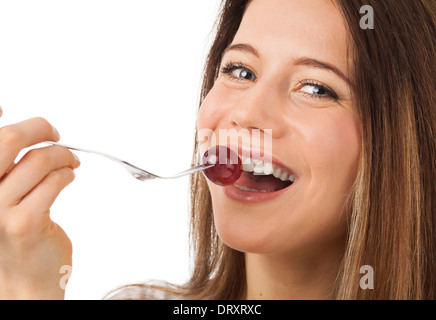 Close up portrait of a nice woman eating raisin, isolated on white Banque D'Images