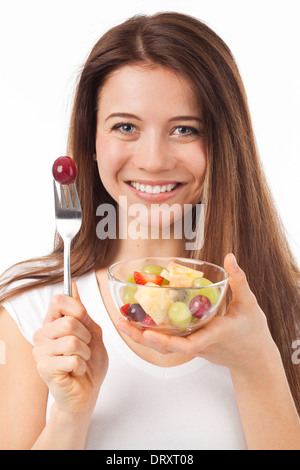 Close up portrait of a Beautiful woman eating fruits, isolated on white Banque D'Images