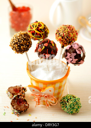 Chocolate cake pops avec les cerises. Recette disponible. Banque D'Images