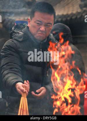 Beijing, Chine, Chine. Jan 31, 2014. Lumière chinois d'encens et prier à la Dongyue temple Taoïste le premier jour de la nouvelle année lunaire de la Chine à Beijing le 31 janvier 2014. Selon le calendrier lunaire chinois, la Chine se félicite de l'année du cheval le 31 janvier. Le cheval, classé septième parmi les 12 animaux sur le zodiaque chinois, est l'un des signes les plus aimés comme il est largement considéré comme un symbole de la force et de la vitesse. © Stephen Shaver/ZUMAPRESS.com/Alamy Live News Banque D'Images