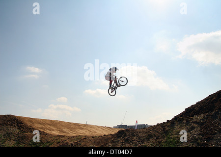 Le BMX rider prend de l'air à la Coupe du monde de BMX Supercross dans le Parc olympique de Londres. Banque D'Images