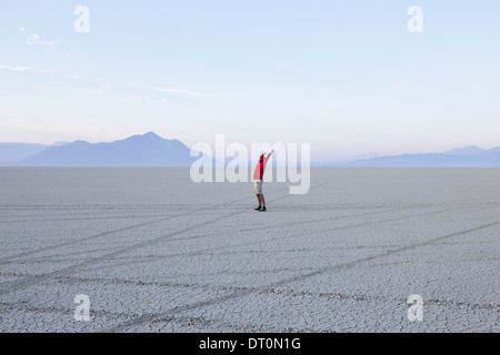 Black Rock Desert NEVADA USA man with arms raised Dawn Black Rock Desert Nevada Banque D'Images