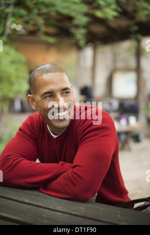 Scènes de la vie urbaine à New York un homme dans un cavalier rouge assis à un banc smiling