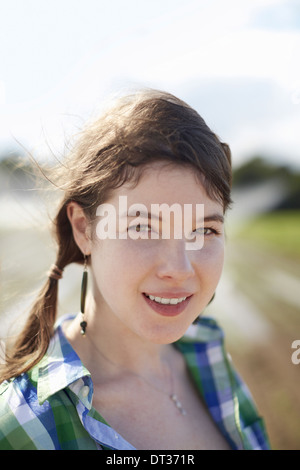 Une jeune femme avec des tresses, chemise à carreaux bleu vert Banque D'Images