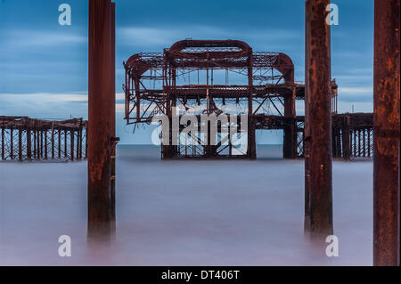 Brighton, Sussex, UK. 7 février 2014. Une autre tempête est prévue et les amateurs de la célèbre Brighton West Pier rassembler sur la plage en ce qui pourrait être un dernier adieu à la structure de la rouille. Une grande partie de il s'est effondré mercredi, personne ne sait combien de temps le reste peut contenir jusqu'. Crédit photo : Julia Claxton/Alamy Live News Banque D'Images