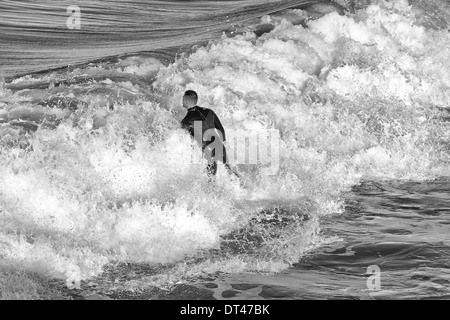 Photo en noir et blanc d'Un homme surfant à Hermosa Beach, Los Angeles, Californie, États-Unis Banque D'Images