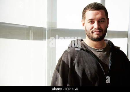 Portrait of young man wearing hooded top Banque D'Images