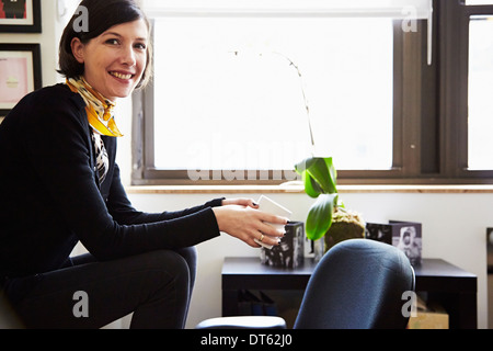 Businesswoman sitting in office Banque D'Images