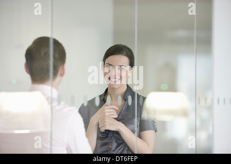 Des collègues en discussion à travers le verre Banque D'Images
