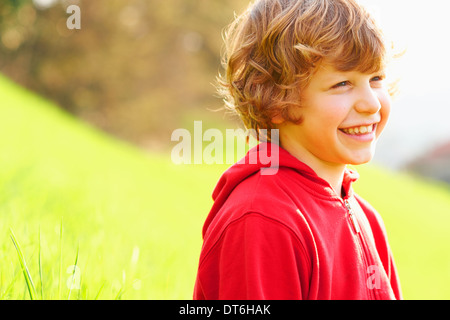 Jeune garçon in grassy field Banque D'Images