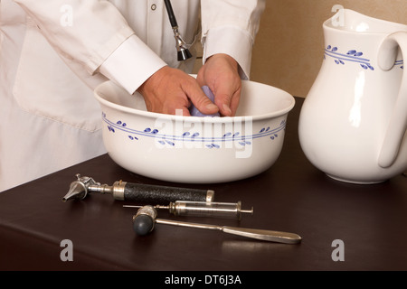 Médecin à l'ancienne laver les mains dans un bassin Banque D'Images