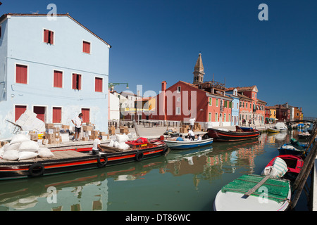 Burano - les hommes du déchargement d'un bateau en face de maisons colorées sur l'île de Burano, lagune de Venise, Italie Banque D'Images