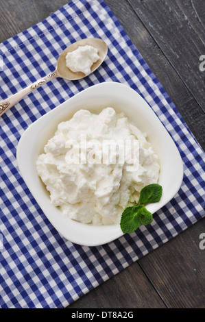 Dans un bol de fromage ricotta à la menthe sur fond de bois Banque D'Images