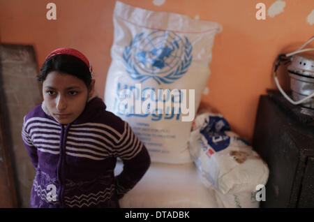 Gaza, bande de Gaza. Feb 13, 2014. Un 12-year-old fille palestinienne Rula Ali, qui souffre d'une laryngite chronique, est vu à sa maison dans le camp de réfugiés de Nuseirat, centre de la bande de Gaza, le 13 février 2014. Plusieurs patients palestiniens comme Rula qui sont en quête d'un traitement en Israël se sont vu refuser l'accès par les autorités israéliennes par Erez avec Gaza pour la tenue de documents en utilisant le terme "État de Palestine". © Wissam Nassar/Xinhua/Alamy Live News Banque D'Images