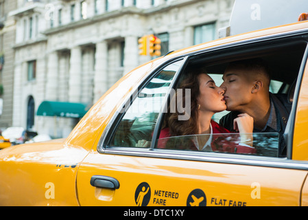 Jeune couple touristiques taxi jaune, New York City, USA Banque D'Images