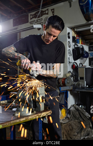 Homme mature pièces de soudage en atelier de réparation de moto Banque D'Images