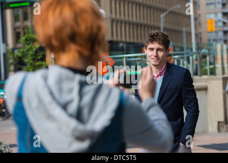 Young woman photographing boyfriend