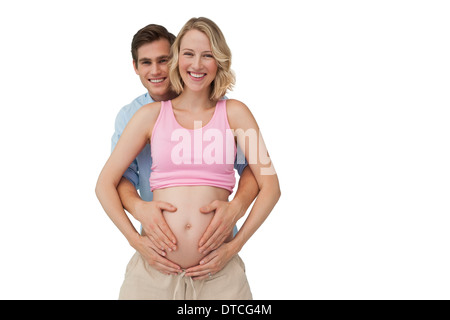 Les futures mères parents smiling holding baby bump Banque D'Images