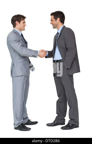 Happy business partners shaking hands Banque D'Images