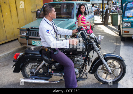 Policier philippin sur une moto au centre-ville de Manille, Philippines Banque D'Images