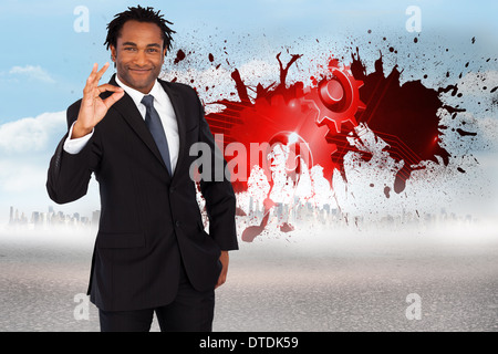 Image composite de businessman showing ok sign Banque D'Images