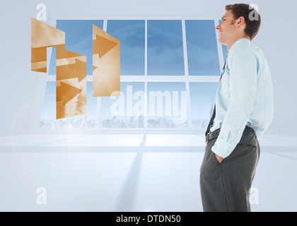 Composite image of businessman standing with hand in pocket Banque D'Images