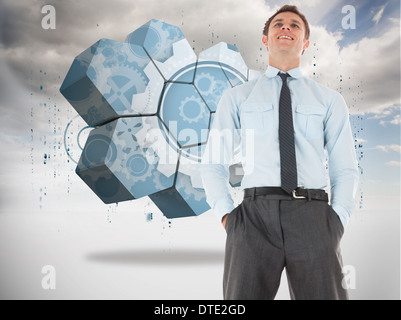 Composite image of businessman standing with hands in pockets Banque D'Images