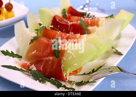 Melon mûr avec du jambon, parmesan on white plate, Close up Banque D'Images