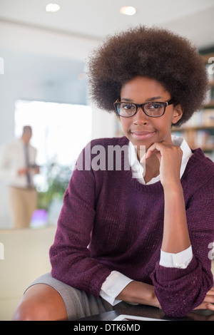 Businesswoman smiling in living room Banque D'Images