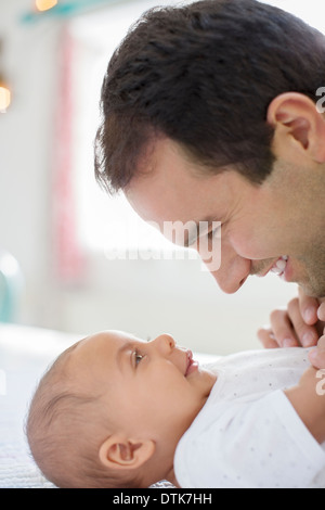 Père adorant baby boy on table Banque D'Images