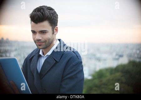 Businessman using digital tablet outdoors Banque D'Images