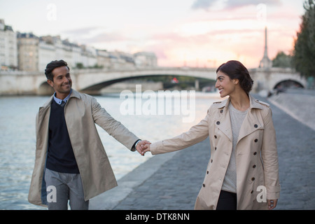 Couple holding hands le long de la rivière Seine, Paris, France Banque D'Images