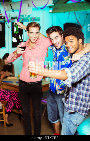 Les hommes toasting each other at party Banque D'Images