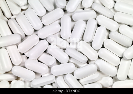 Pile de type capsule blanc pilules sur un fond clair. Banque D'Images