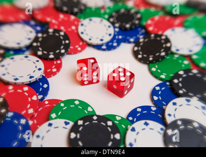 Deux dés entouré par des jetons de poker Banque D'Images