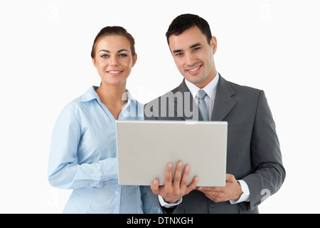 Smiling business partners with laptop Banque D'Images