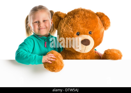 Petite fille avec de grands ours derrière tableau blanc Banque D'Images