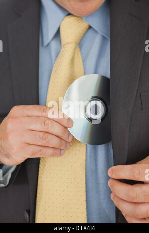 Businessman putting CD dans sa poche Banque D'Images